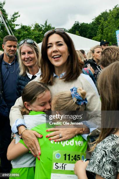 Crown Princess Mary of Denmark is warmly welcomed by kids during the 'Children's Relay Run' in Faelledparken on June 10, 2017 in Copenhagen, Denmark....