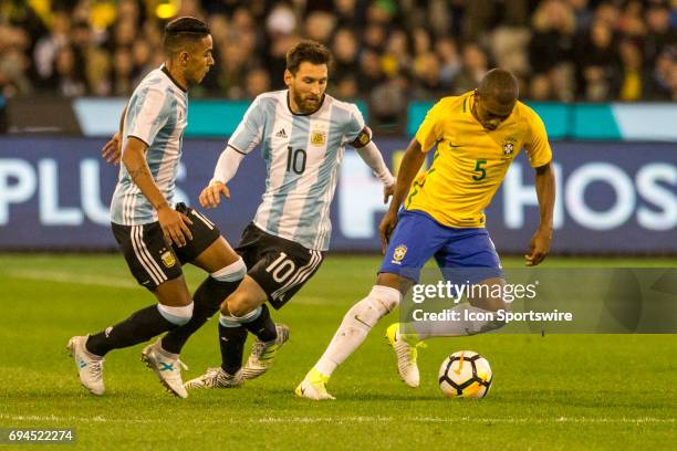 Fernando Roza of the Brazilian National Football Team controls the ball in front of Lionel Messi of the Argentinan National Football Team and Jose...