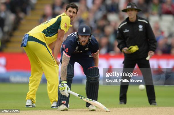 Ben Stokes of England watches with Mitchell Starc of Australia as Eoin Morgan is run out during the ICC Champions Trophy match between England and...