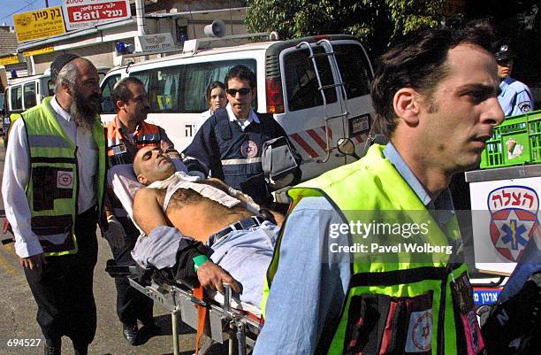 Israeli medics evacuate a wounded man from the scene of a suicide bombing January 25, 2002 in Tel Aviv. A suicide bomber blew himself up in a crowded...