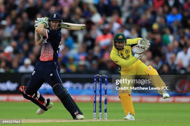 Ben Stokes of England hits the ball towards the boundary, as Matthew Wade of Australia looks on during the ICC Champions Trophy match between England...