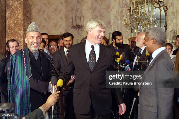 Afghanistans interim Prime Minister Hamid Karzai, Canadian Deputy Prime Minister John Manley, and U.N. Secretary General Kofi Annan laugh together...