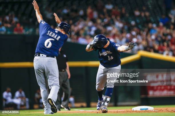 Milwaukee Brewers left fielder Hernan Perez celebrates with Milwaukee Brewers third base coach Ed Sedar after hitting a home run during the MLB...