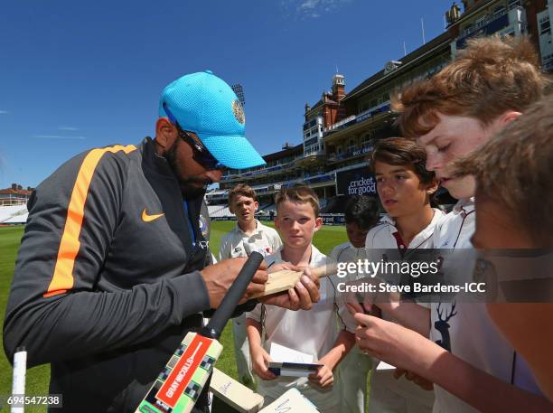 Mohammed Shami of India signs autographs for local children playing during the ICC Cricket For Good coaching session with India at The Kia Oval on...