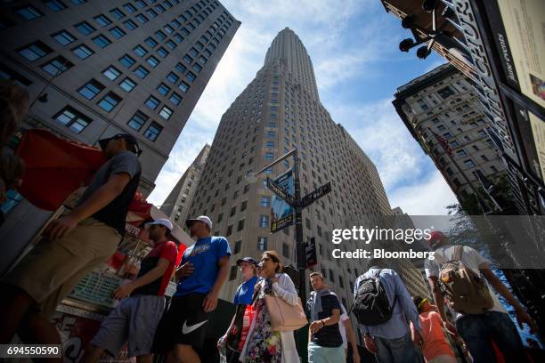 Pedestrians walk past the One Wall Street tower on the corner of Broadway and Wall Street in New York, U.S., on Friday, June 9, 2017. JPMorgan Chase...