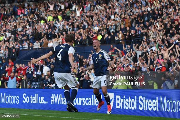 Scotland's striker Leigh Griffiths celebrates with Scotland's defender Christophe Berra after scoring their second goal during the group F World Cup...