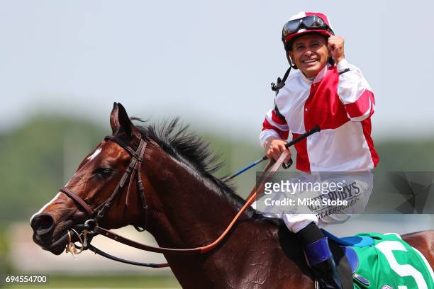 Songbird with Jockey Mike Smith celebrates after winning The Ogden Phipps during the 149th running of the Belmont Stakes at Belmont Park on June 10,...