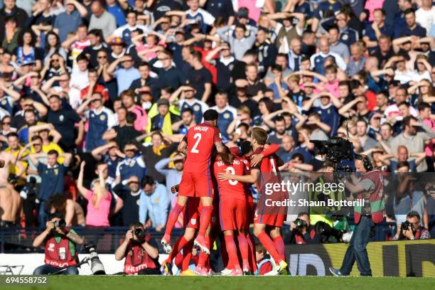 Harry Kane of England celebrates scoring his sides second goal with his team mates during the FIFA 2018 World Cup Qualifier between Scotland and...