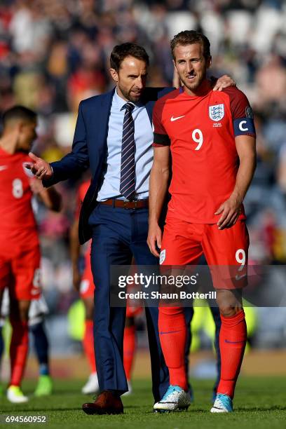 Gareth Southgate, Manager of England and Harry Kane of England speak to each other after the FIFA 2018 World Cup Qualifier between Scotland and...