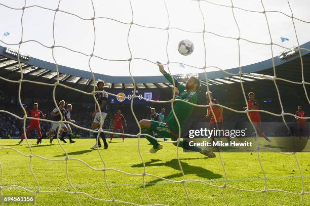 Alex Oxlade-Chamberlain of England scores his sides first goal past Craig Gordon of Scotland during the FIFA 2018 World Cup Qualifier between...