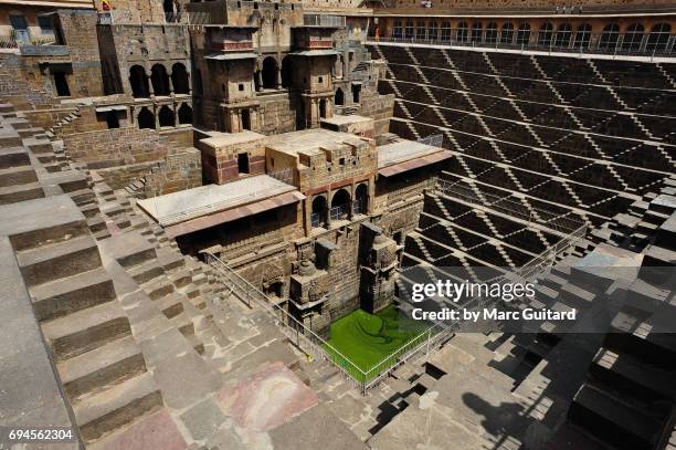 a shot of the incredible chand baori stepwell and it's temple, abhaneri, rajasthan, india - abhaneri foto e immagini stock