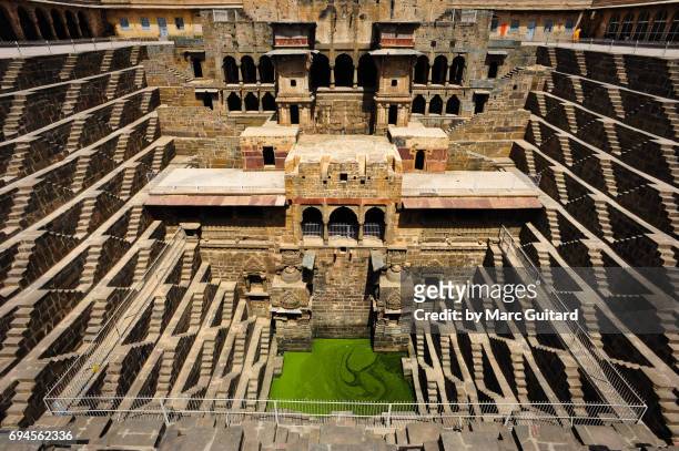 a shot of the incredible chand baori stepwell and it's temple, abhaneri, rajasthan, india - abhaneri stock-fotos und bilder