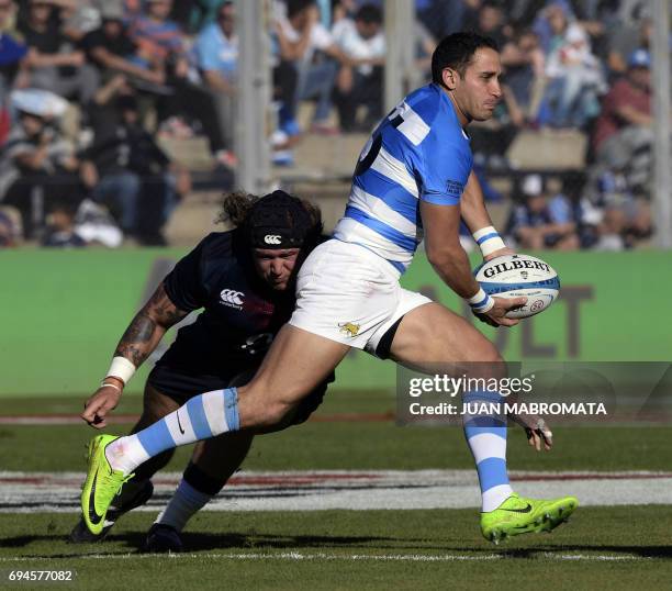 Argentina's Los Pumas fullback Joaquin Tuculet runs through a tackle by England's prop Harry Williams during their Rugby Union test match at San Juan...