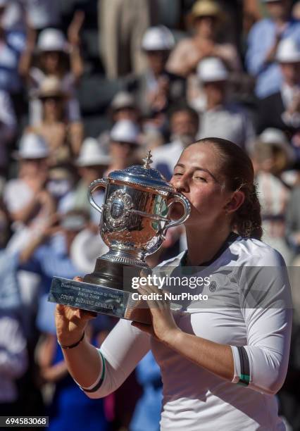 Jelena Ostapenko of Latvia kiss the trophy during the award ceremony after the womens final at Roland Garros Grand Slam Tournament - Day 14 on June...