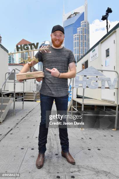 Singer Eric Paslay poses with an award at the HGTV Lodge during CMA Music Fest on June 10, 2017 in Nashville, Tennessee.