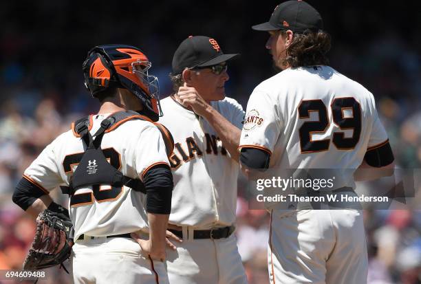 Pitching coach Dave Righetti and catcher Buster Posey of the San Francisco Giants comes out to talk with pitcher Jeff Samardzija after Samardzija...