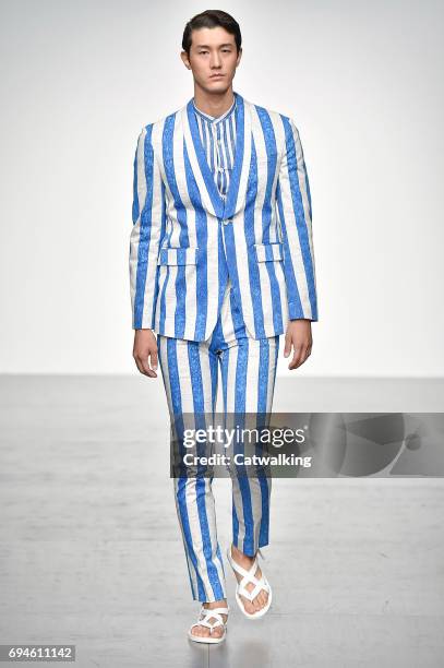 Model walks the runway at the Songzio Spring Summer 2018 fashion show during London Menswear Fashion Week on June 10, 2017 in London, United Kingdom.