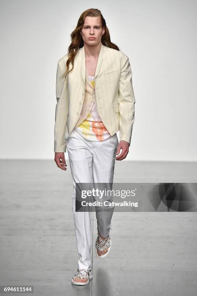 Model walks the runway at the Songzio Spring Summer 2018 fashion show during London Menswear Fashion Week on June 10, 2017 in London, United Kingdom.