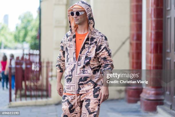 Alessandro Altomare wearing a hooded suit with print and cap during the London Fashion Week Men's June 2017 collections on June 10, 2017 in London,...