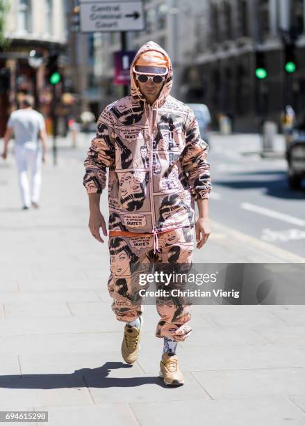 Alessandro Altomare wearing a hooded suit with print and cap during the London Fashion Week Men's June 2017 collections on June 10, 2017 in London,...