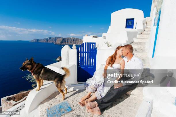 young couple celebrating wedding at santorini island, cyclades, greece - santorini wedding stockfoto's en -beelden