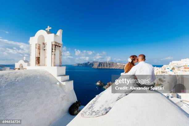 young couple celebrating wedding at santorini island, cyclades, greece - santorini wedding stockfoto's en -beelden