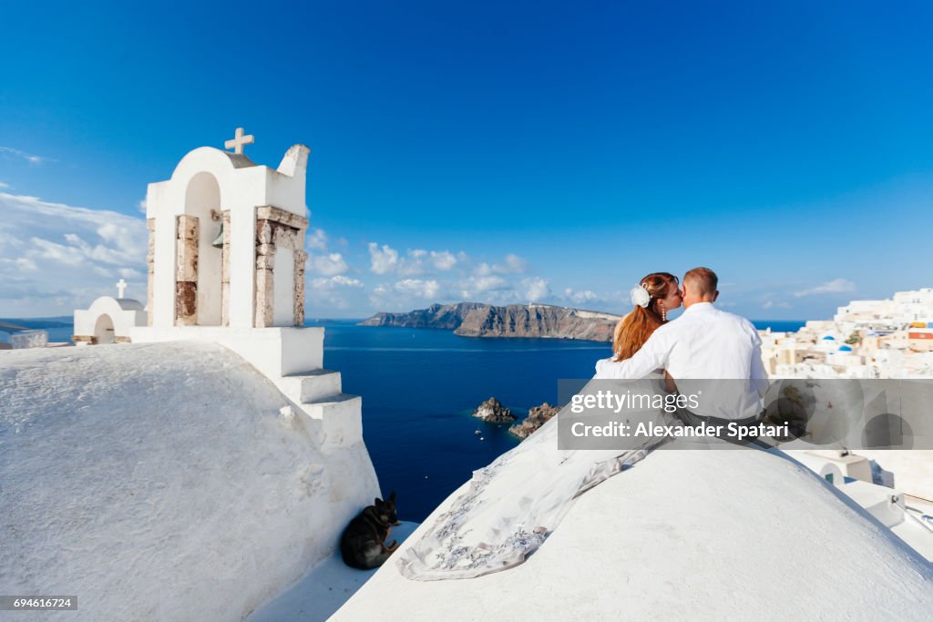 Young couple celebrating wedding at Santorini island, Cyclades, Greece