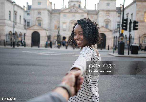 woman leading the way while traveling in london - follow the leader stock pictures, royalty-free photos & images