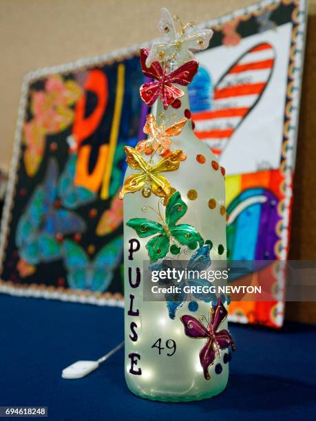 Lighted memento made to honor the victims on display during a memorial service on the first anniversary of the Pulse nightclub shootings, at the...