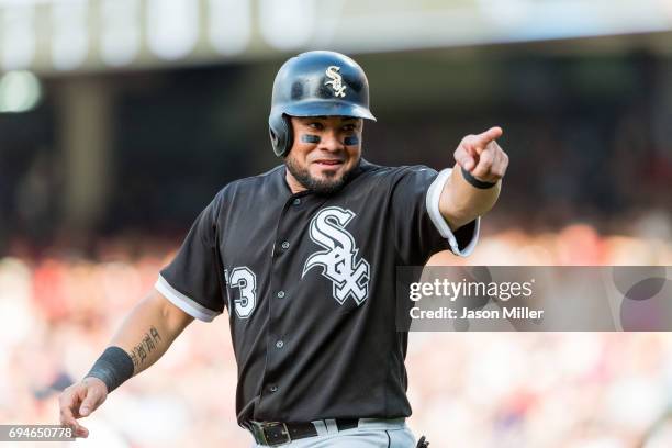 Melky Cabrera of the Chicago White Sox jokes with players in the Cleveland Indians dugout while on third base during the first inning at Progressive...