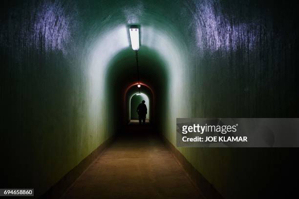 Man walks inside of the Skrilje bunker located in a forest 90 meters bellow the ground on a sealed-off military base near town of Kocevje, Slovenia,...