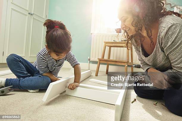 mother and daughter building furniture - bjarte rettedal stock pictures, royalty-free photos & images