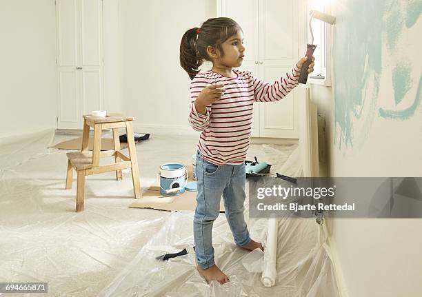 girl painting wall in her bedroom - bjarte rettedal stock pictures, royalty-free photos & images