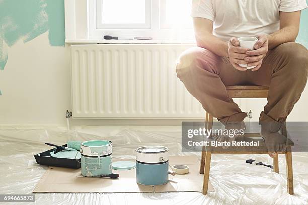 man having coffee break from decorating - brown trousers fotografías e imágenes de stock