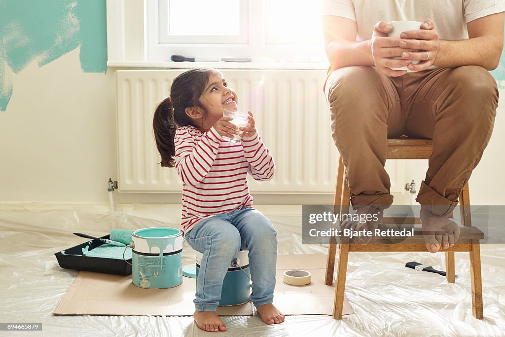 Girl with milk glass smiling at dad