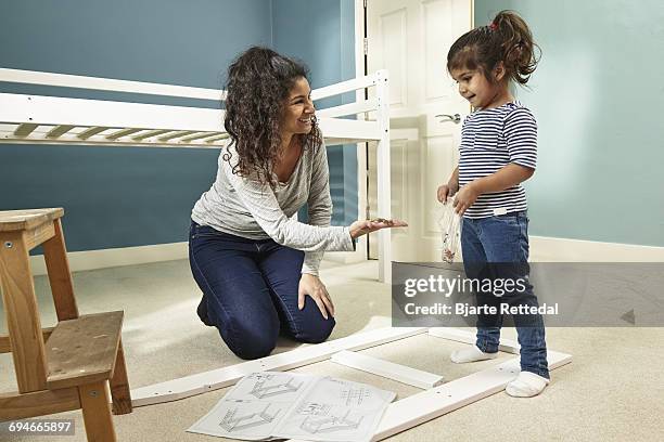 mother and daughter building furniture - bjarte rettedal stock pictures, royalty-free photos & images