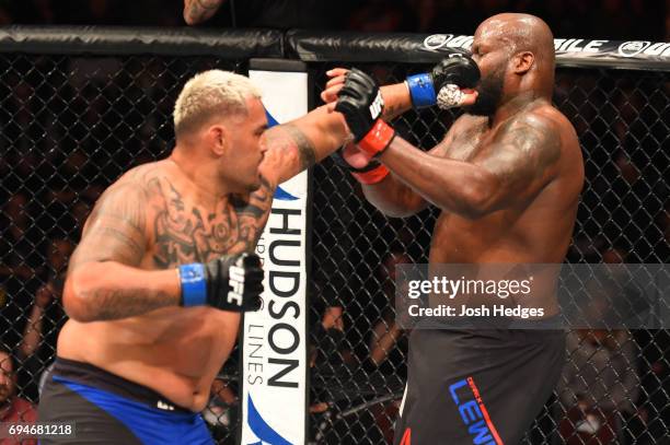 Mark Hunt of New Zealand punches Derrick Lewis in their heavyweight fight during the UFC Fight Night event at the Spark Arena on June 11, 2017 in...