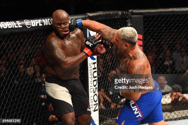 Mark Hunt of New Zealand punches Derrick Lewis in their heavyweight fight during the UFC Fight Night event at the Spark Arena on June 11, 2017 in...