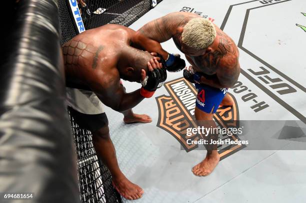 Mark Hunt of New Zealand lands an elbow against Derrick Lewis in their heavyweight fight during the UFC Fight Night event at the Spark Arena on June...