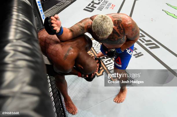 Mark Hunt of New Zealand lands an elbow against Derrick Lewis in their heavyweight fight during the UFC Fight Night event at the Spark Arena on June...