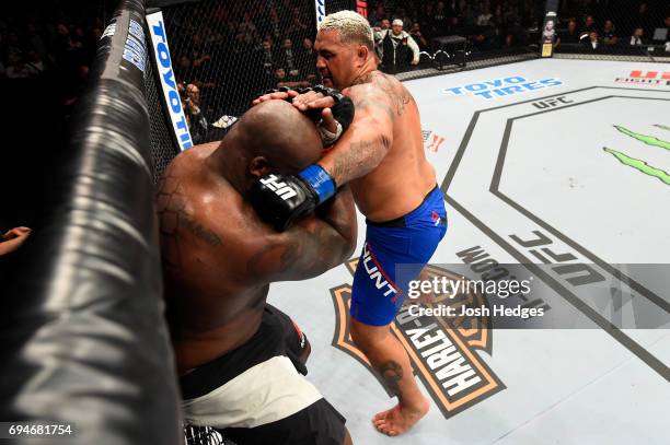 Mark Hunt of New Zealand punches Derrick Lewis in their heavyweight fight during the UFC Fight Night event at the Spark Arena on June 11, 2017 in...