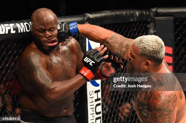 Mark Hunt of New Zealand punches Derrick Lewis in their heavyweight fight during the UFC Fight Night event at the Spark Arena on June 11, 2017 in...