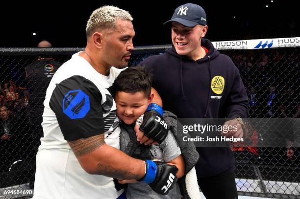 Mark Hunt of New Zealand celebrates with his family after defeating Derrick Lewis in their heavyweight fight during the UFC Fight Night event at the...