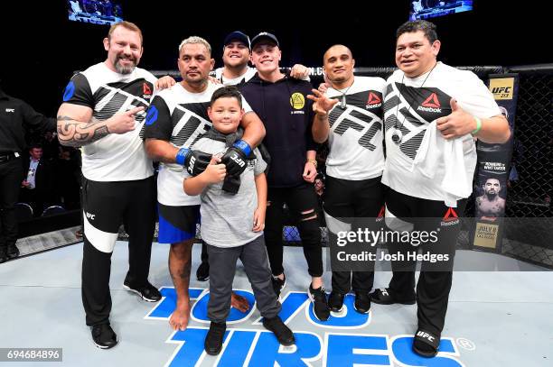 Mark Hunt of New Zealand celebrates with his family and corner after defeating Derrick Lewis in their heavyweight fight during the UFC Fight Night...