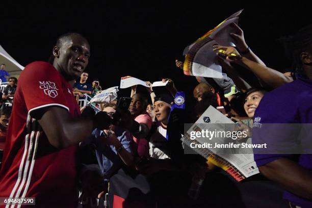 Didier Drogba of Phoenix Rising FC signs autographs for fans after the game against the Vancouver Whitecaps II through fans at Phoenix Rising Soccer...