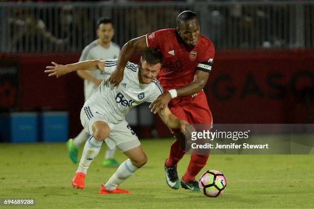Ben McKendry of Vancouver Whitecaps II and Didier Drogba of Phoenix Rising FC battle for the ball in the second half of the match at Phoenix Rising...