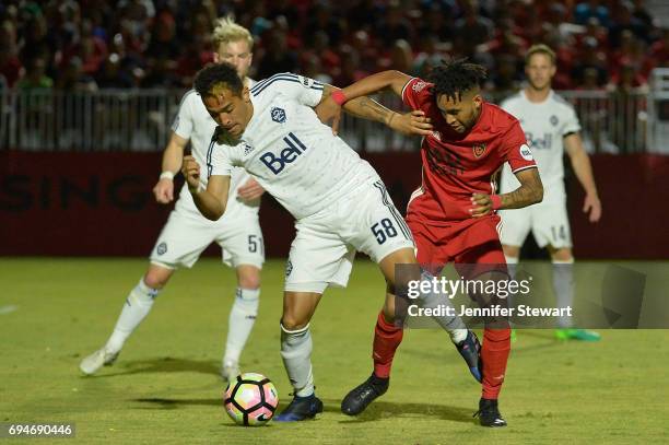 Will Seymore of Vancouver Whitecaps II dribbles by Amadou Dia of Phoenix Rising FC in the second half of the match at Phoenix Rising Soccer Complex...