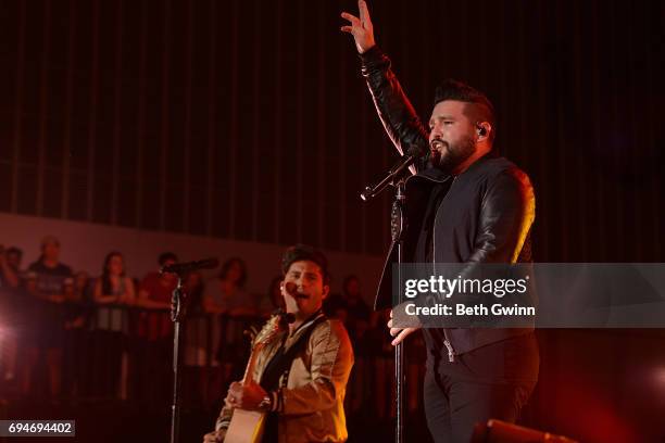 Dan Smyers and Shay Mooney of the band Dan & Shay perform on the Cracker Barrel stage during CMA Fest on June 10, 2017 in Nashville, Tennessee.