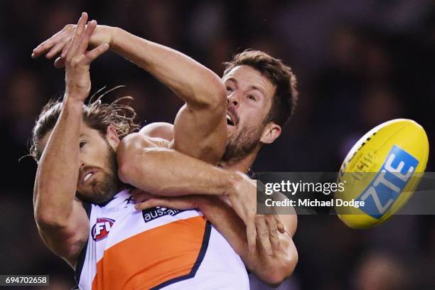 Callan Ward of the Giants and Matthew Wright of the Blues compete for the ball during the round 12 AFL match between the Carlton Blues and the...