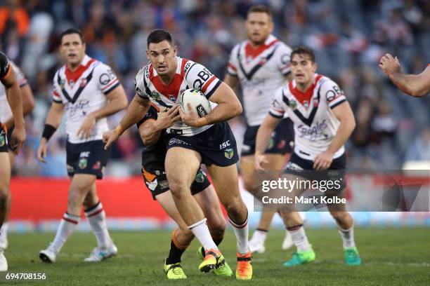 Ryan Matterson of the Roosters is tackled during the round 14 NRL match between between the Wests Tigers and the Sydney Roosters at Campbelltown...